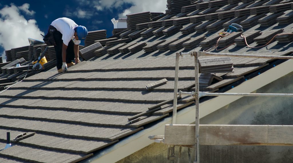 roofers laying new roofing tiles